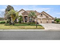 Beautiful two-story home with stone accents and a three-car garage at 6861 Sw 179Th Avenue Rd, Dunnellon, FL 34432