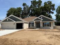 Charming one-story home with a two-car garage and beautifully landscaped front yard at 7 Nw 45Th Loop, Ocala, FL 34470