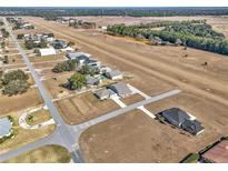 Aerial view of a home on an airfield, with surrounding properties and landscape at 7225 Se 92Nd St, Ocala, FL 34472