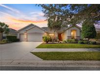 Beautiful one-story home with three car garage and manicured lawn at 7316 Sw 94Th Ct, Ocala, FL 34481