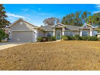 Single-story home with a two-car garage and well-manicured lawn at 8120 Sw 56Th Ter, Ocala, FL 34476