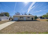 Cute yellow house with a spacious yard and a single car garage at 8274 Sw 106Th Pl, Ocala, FL 34481