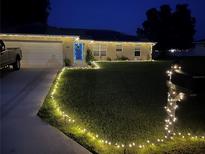 Attractive single-story home with a well-manicured lawn at night at 1561 Ne 160Th Pl, Citra, FL 32113