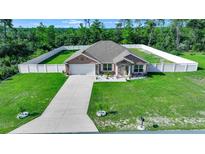 Single-story house with a fenced yard and driveway at 2701 Sw 175Th Loop, Ocala, FL 34473