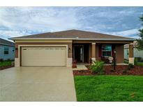 Charming single-story home featuring a two-car garage, well-maintained lawn, and inviting front porch at 8902 Sw 75Th Loop, Ocala, FL 34481