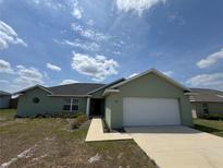 Charming single-story home with a two-car garage and manicured lawn at 6414 Sw 67Th Pl, Ocala, FL 34476