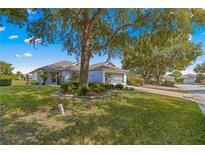 Single-story home with a landscaped yard and attached garage, set back from the street at 9014 Sw 96Th Ter, Ocala, FL 34481