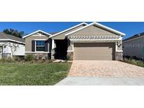 One-story home with a two-car garage and landscaped lawn at 4062 Nw 48Th Terrace Rd, Ocala, FL 34482