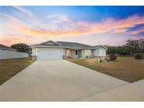 Charming single-story home with a two-car garage and well-maintained lawn at 4470 Nw 2Nd Ct, Ocala, FL 34475