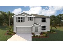 Two story home with gray exterior, two car garage, and landscaping at 4755 Sw 88Th Ln, Ocala, FL 34476