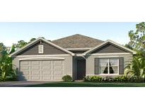 One-story home with gray siding, neutral accents, and a two-car garage at 4763 Sw 88Th Ln, Ocala, FL 34476