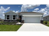 Charming single-story home with stone accents, a two-car garage, and a well-manicured lawn at 6238 Sw 93Rd Loop, Ocala, FL 34476