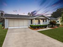 Single-story home with carport and landscaped yard at 8240 Sw 107Th Ln, Ocala, FL 34481