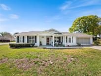 Charming single-story home with a well-manicured lawn, attached garage, and inviting front porch at 8510 Sw 108Th Place Rd, Ocala, FL 34481