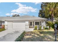 Charming one story home featuring a well manicured front yard and an attached single car garage at 8707 Sw 95Th Ln # G, Ocala, FL 34481