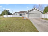 Charming single-story home featuring a well-manicured lawn and attached two-car garage at 2 Hemlock Terrace Trl, Ocala, FL 34472