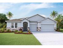 Charming single-story home featuring a three-car garage and professionally landscaped front yard at 3079 Canopy Oak Blvd, Wildwood, FL 34785