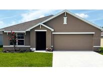 Charming single-story home with well-manicured lawn and attached two-car garage at 7144 Se 113Th Ln, Belleview, FL 34420