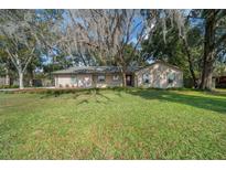 Charming single-story home with mature trees and a well-manicured lawn in a quiet neighborhood at 2923 Se 14Th St, Ocala, FL 34471