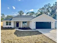 Charming new construction home featuring a modern farmhouse design, dark accents, and a well-manicured lawn at 3684 Se 130Th Pl, Belleview, FL 34420