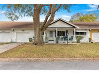 Charming single-story home featuring a covered front porch and well-maintained landscaping at 8891 Sw 96Th Ln # E, Ocala, FL 34481