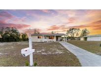 Charming single story home with a large front yard, covered porch, and long driveway at 10498 Sw 99Th Ave, Ocala, FL 34481