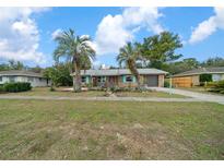 Charming single-story home with landscaped yard and beautiful palm trees at 15052 Sw 43Rd Terrace Rd, Ocala, FL 34473