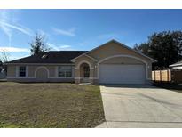 Charming single-story home with a two-car garage and well-maintained front yard at 3940 Sw 138Th Pl, Ocala, FL 34473