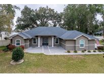 Charming one-story home featuring a well-manicured lawn and an inviting entrance with stone columns at 4604 Se 33Rd Pl, Ocala, FL 34480