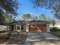 Charming single-story home with a two-car garage, manicured landscaping, and a welcoming front entrance at 5155 Sw 39Th St, Ocala, FL 34474