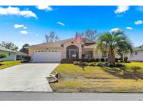 Charming single-story home featuring a well-maintained lawn and a welcoming screened entrance at 6188 Sw 84Th St, Ocala, FL 34476