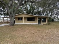 Charming single-story home featuring a covered carport and a welcoming front porch at 8973 Sw 104Th Ln, Ocala, FL 34481