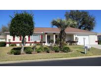 Charming single-story home features well-manicured landscaping and red shutters at 11353 Sw 138Th Ln, Dunnellon, FL 34432