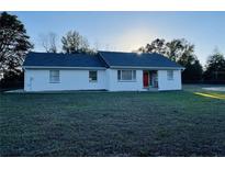 Charming single story home with a well maintained lawn, clean exterior, and orange front door at 15040 Sw 29Th St, Ocala, FL 34481