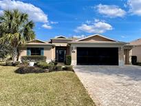 Charming single-story home with a well-manicured lawn, mature landscaping and brick paver driveway at 16191 Sw 12Th Ter, Ocala, FL 34473