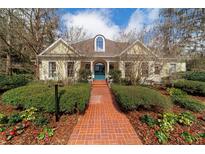 Stunning single Gathering home featuring a brick walkway, lush landscaping and a charming, light yellow facade at 2775 Sw 53Rd St, Ocala, FL 34471