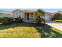 Charming home with manicured lawn, lush landscaping, and inviting curb appeal at 9704 Sw 95Th Loop, Ocala, FL 34481