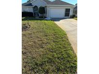 Well-maintained lawn and charming single-story home with attached garage at 11221 Sw 71St Ct, Ocala, FL 34476