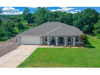 Charming single-story home featuring a well-manicured lawn and inviting front porch at 4160 Sw 98Th St, Ocala, FL 34476