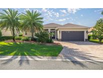 Charming single story home with beautiful landscaping, paver driveway and spacious two car garage at 10138 Lake Miona Way, Oxford, FL 34484