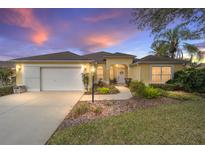 Charming single Gathering home with a two-car garage, a well-manicured lawn and beautiful sunset at 3001 Rugby Way, The Villages, FL 32162