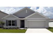 Charming single-story home showcasing a well-manicured lawn and attached two-car garage at 4739 Sw 88Th Ln, Ocala, FL 34476