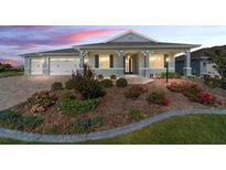 Beautiful single-story home featuring a well-manicured lawn and inviting front porch at dusk at 8107 Sw 92Nd Cir, Ocala, FL 34481