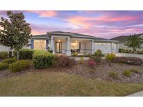 Charming single-story home with manicured landscaping and covered porch at sunset at 9270 Sw 89Th Street Rd, Ocala, FL 34481