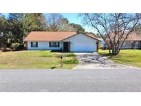 Charming single-story home with a well-maintained lawn and attached garage at 13718 Sw 40Th Cir, Ocala, FL 34473