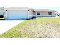 Charming single-story home with attached two-car garage and well-maintained front yard at 434 Bar Ct, Kissimmee, FL 34759