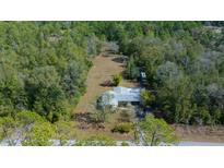 Idyllic home nestled among mature trees on a sprawling lot with plenty of privacy at 4445 Sw Azalea Ct, Dunnellon, FL 34431