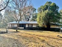 Charming single-story home with stone accents, mature trees, and a metal roof at 4530 Ne 112Th Ln, Anthony, FL 32617