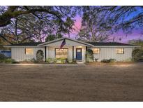 Charming single-story home featuring a freshly painted exterior and an inviting entrance with an American flag at 1126 Ne 34Th Ave, Ocala, FL 34470