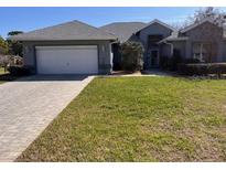 Charming single-story home with well-maintained lawn and brick paved driveway at 11593 Sw 75Th Cir, Ocala, FL 34476